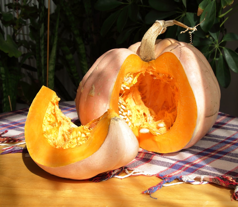 a pumpkin cut in half sitting on a table