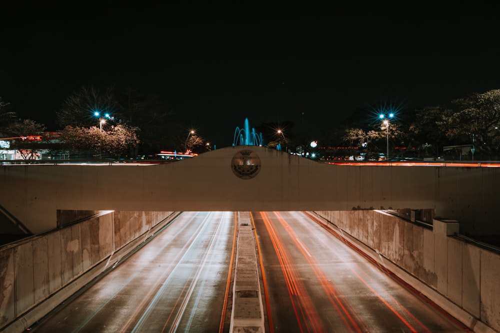 a view of a city street at night from a bridge