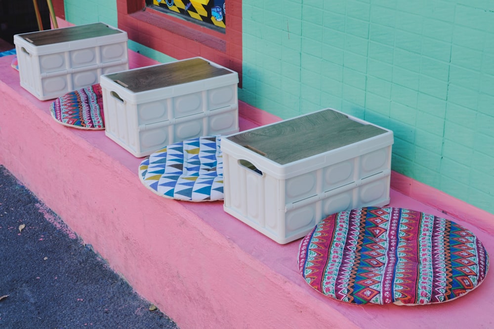 three storage containers sitting on the side of a building