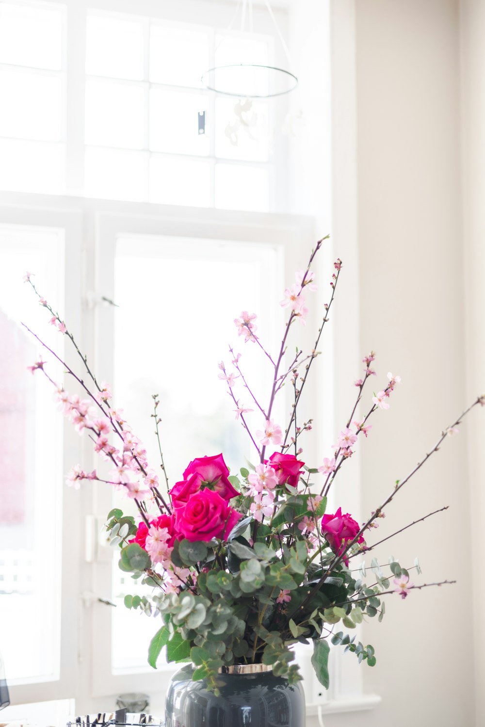 a vase filled with pink flowers on top of a table