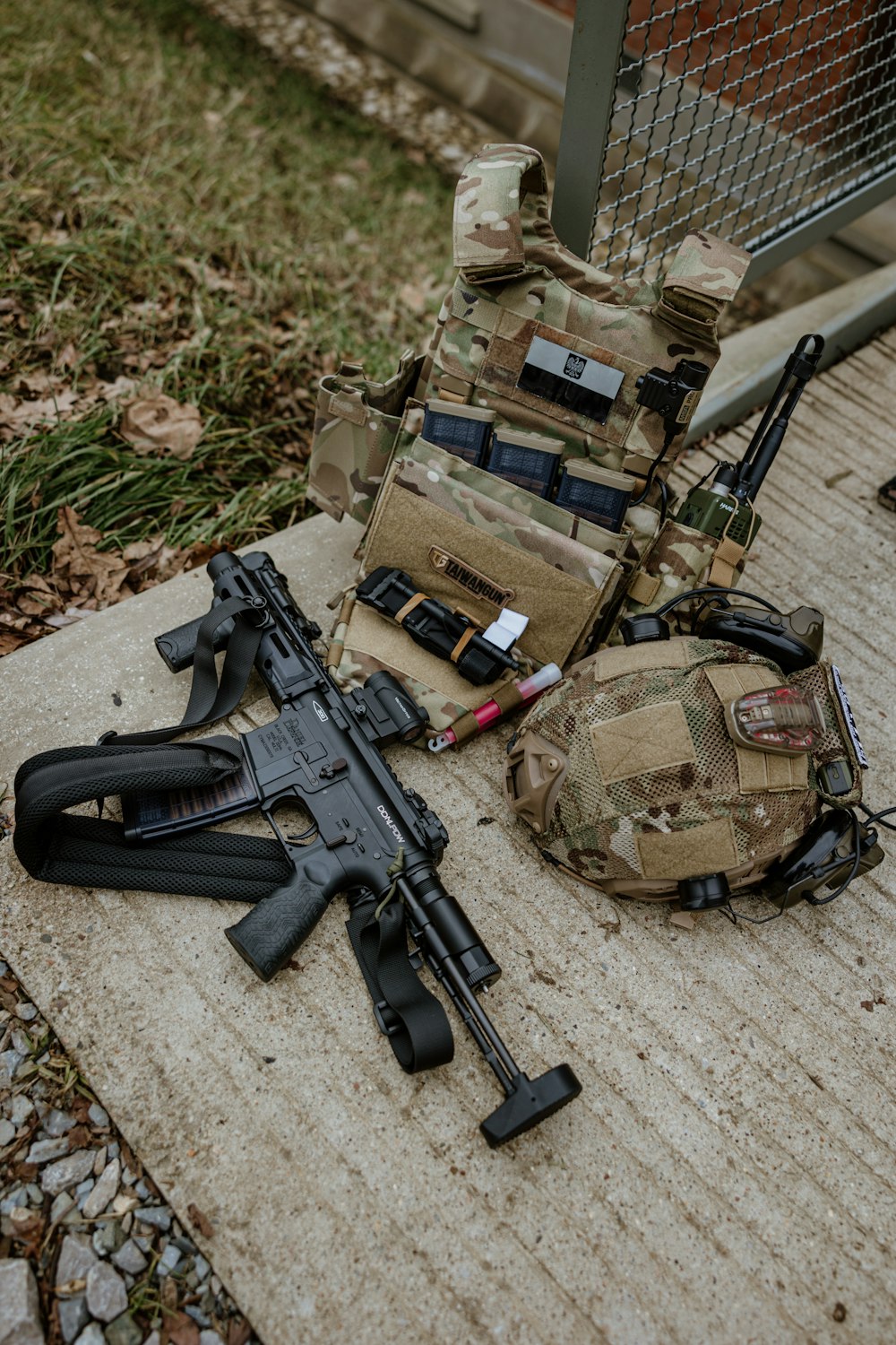a couple of guns and a backpack on a bench