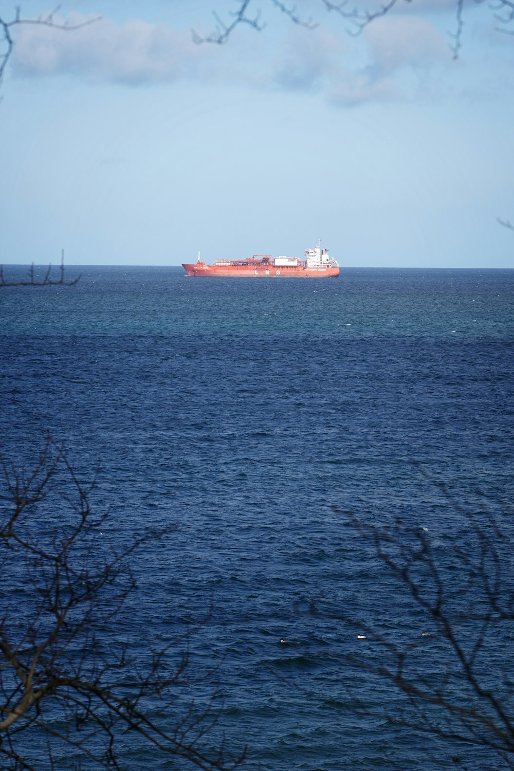 a large cargo ship in the middle of the ocean