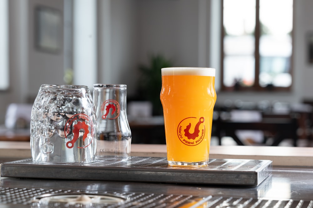 a glass of beer sitting on top of a table