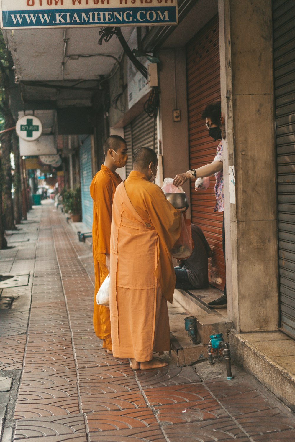a group of monks standing outside of a building
