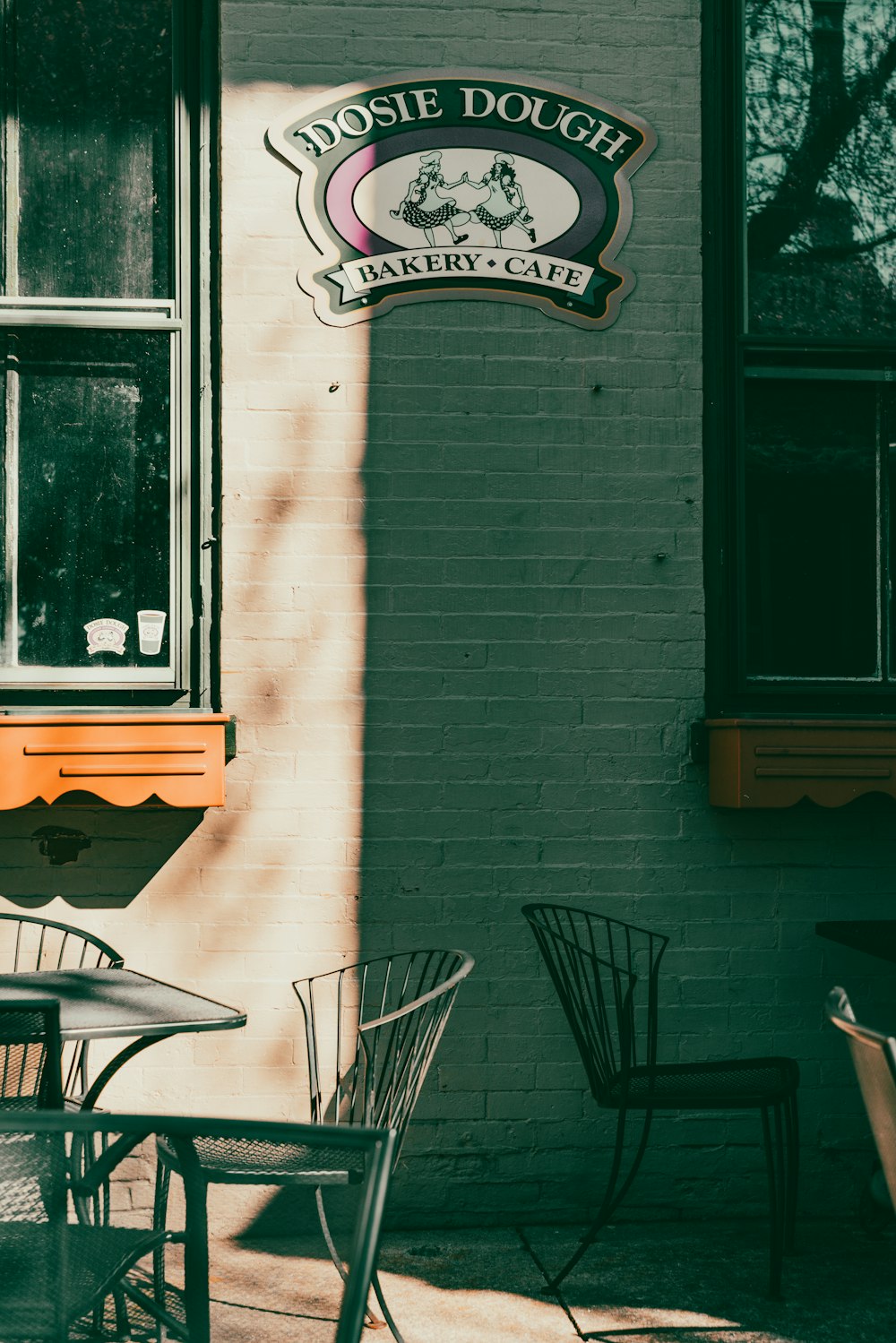 the outside of a restaurant with tables and chairs