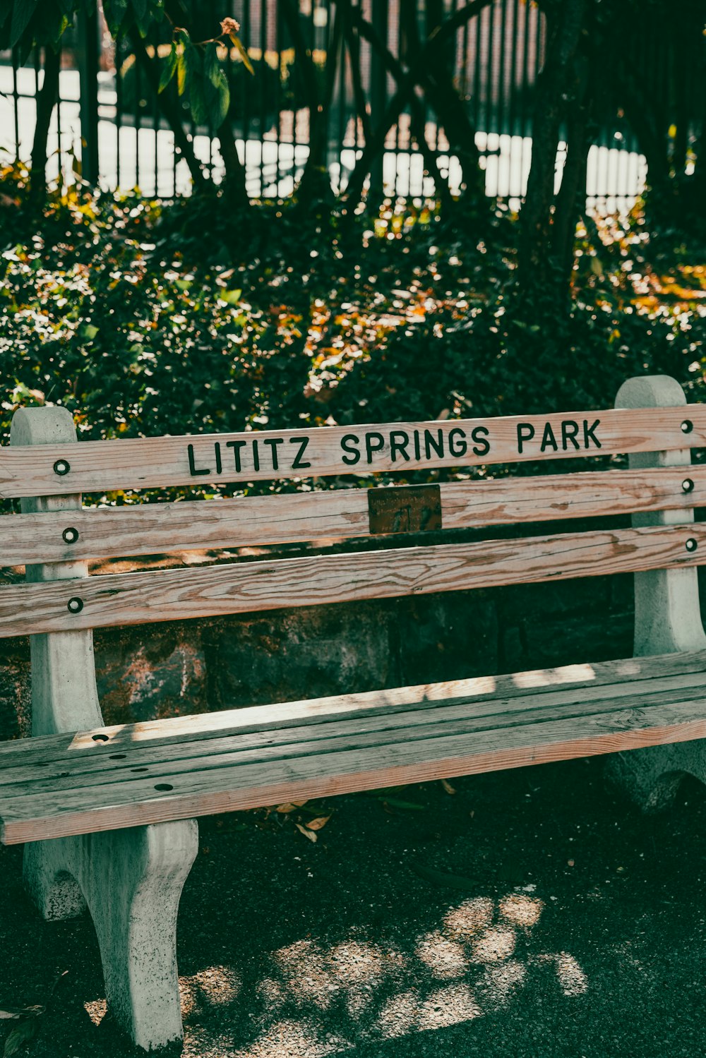 a park bench with a street sign on it