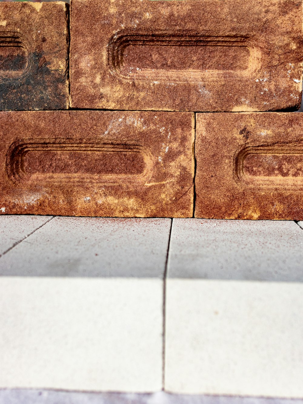 a wooden bench sitting on top of a sidewalk