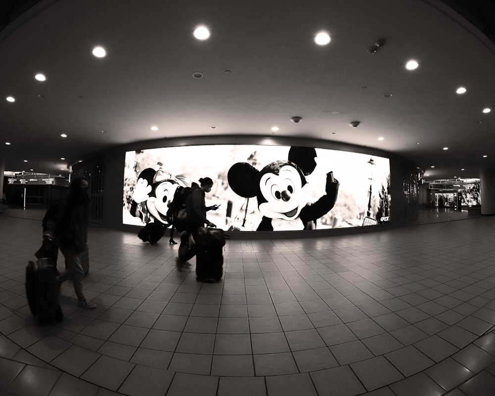 a black and white photo of people with luggage