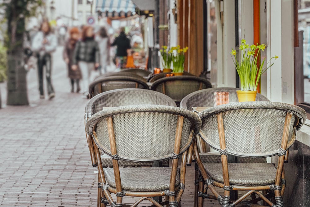 a couple of chairs sitting next to each other on a sidewalk