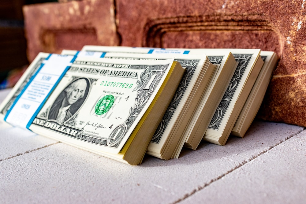 a stack of money sitting on top of a table