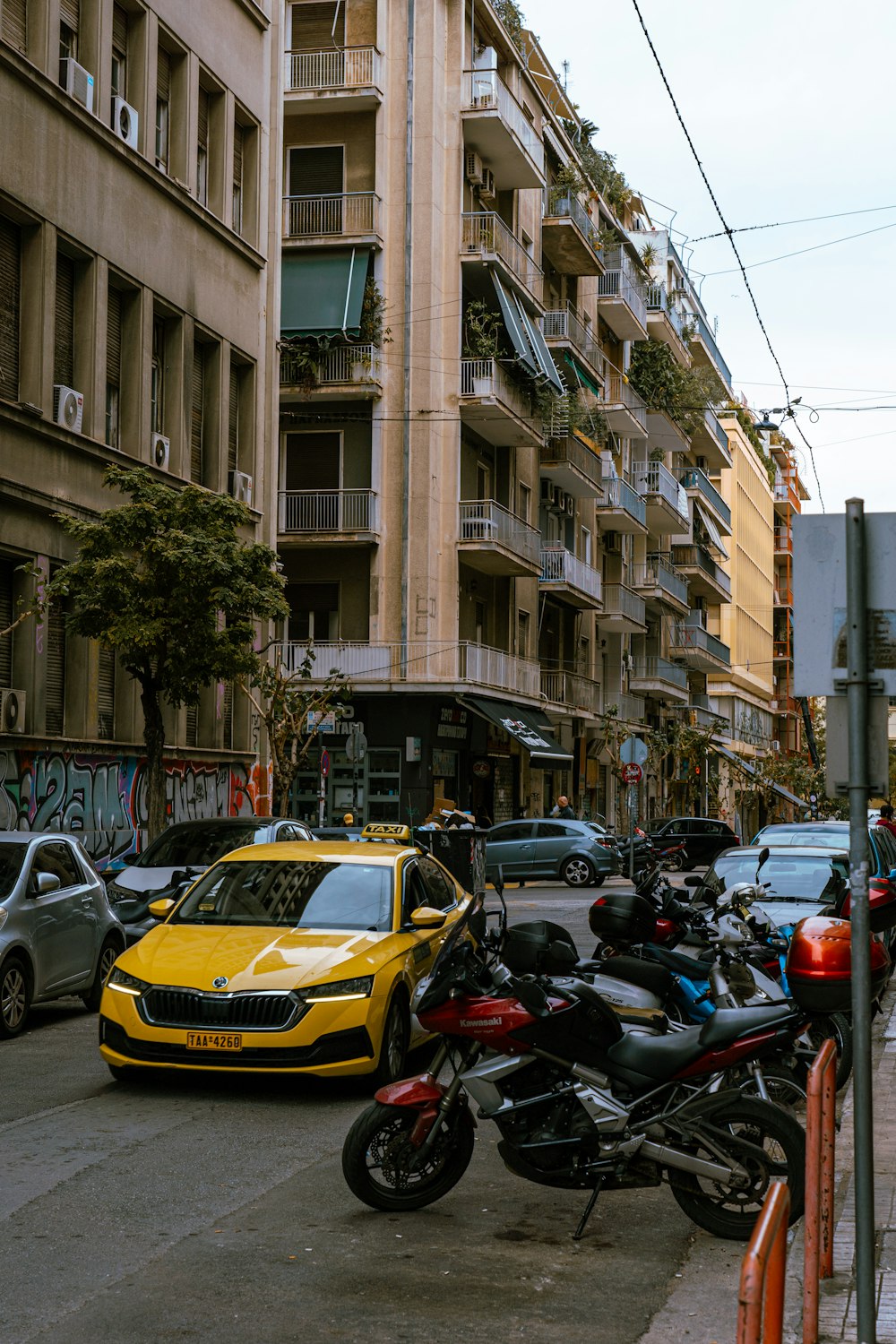 a yellow car parked on the side of a street