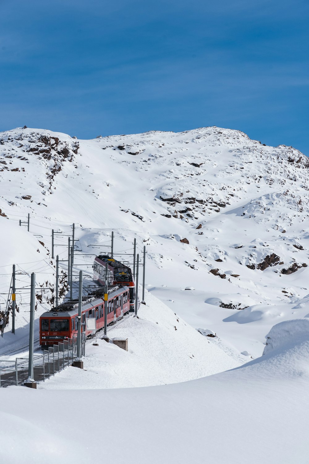 a train traveling through a snow covered mountain