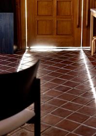 a chair sitting in a room next to a wooden door