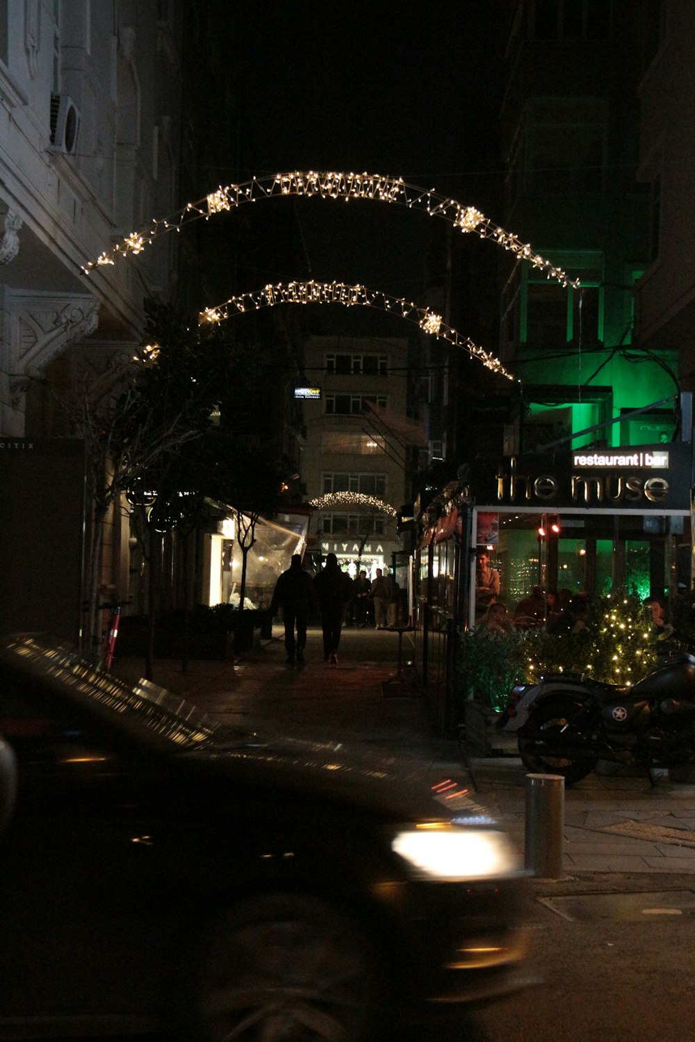 a car driving down a city street at night