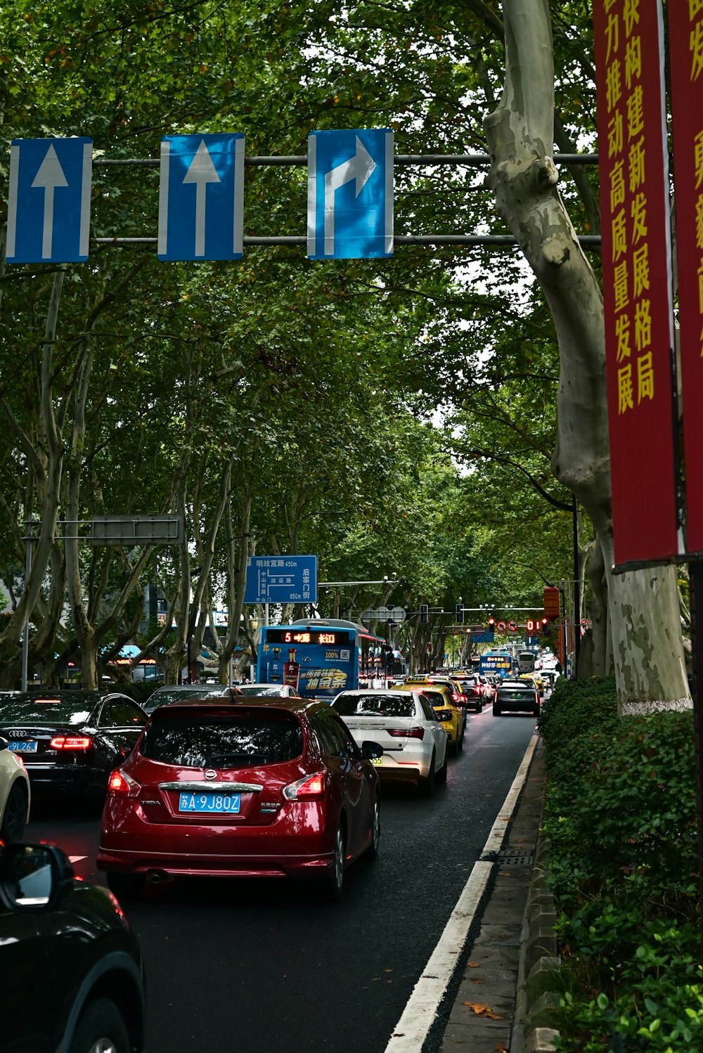 a street filled with lots of traffic next to trees