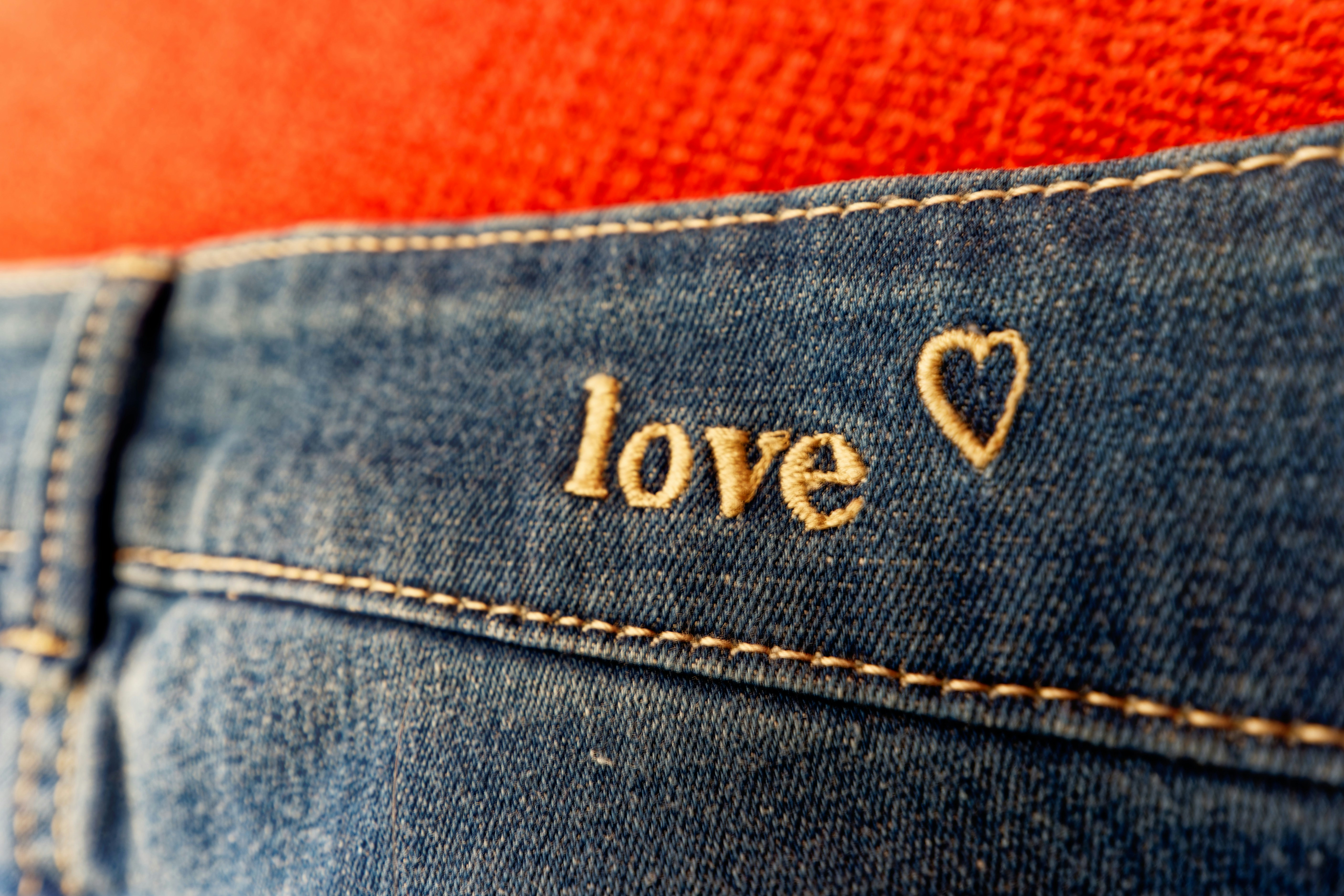 a pair of jeans with the word love written on them