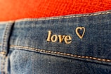a pair of jeans with the word love written on them