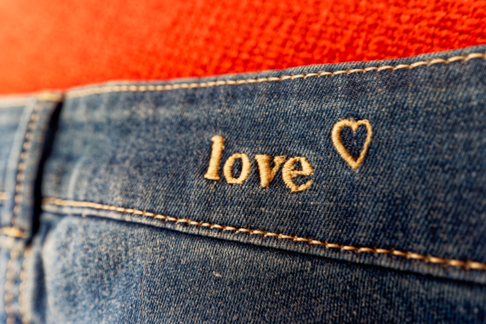 a pair of jeans with the word love written on them