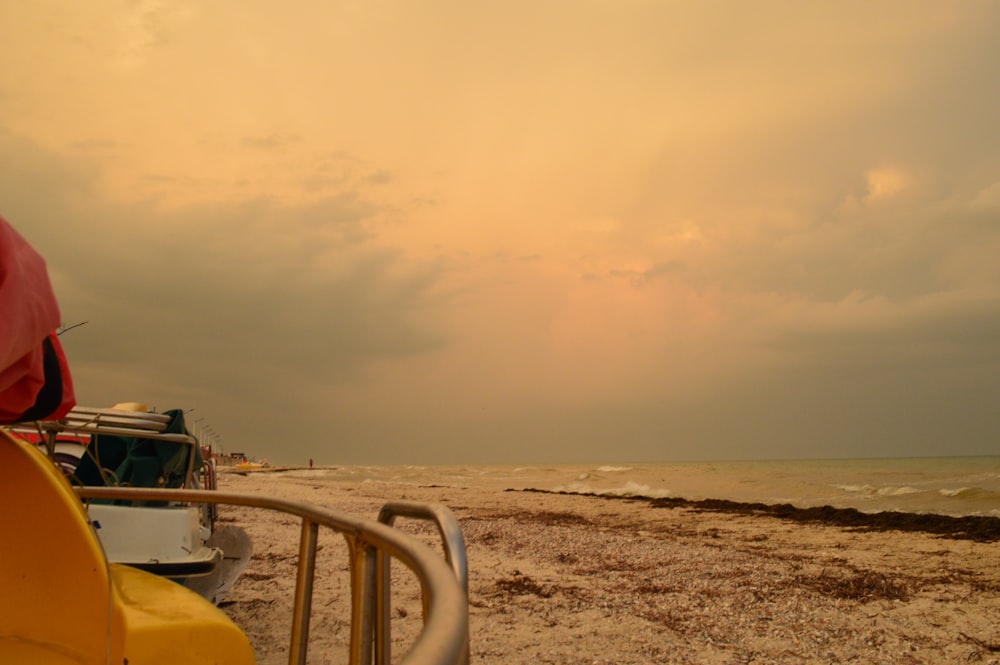 a boat is parked on the beach near the water