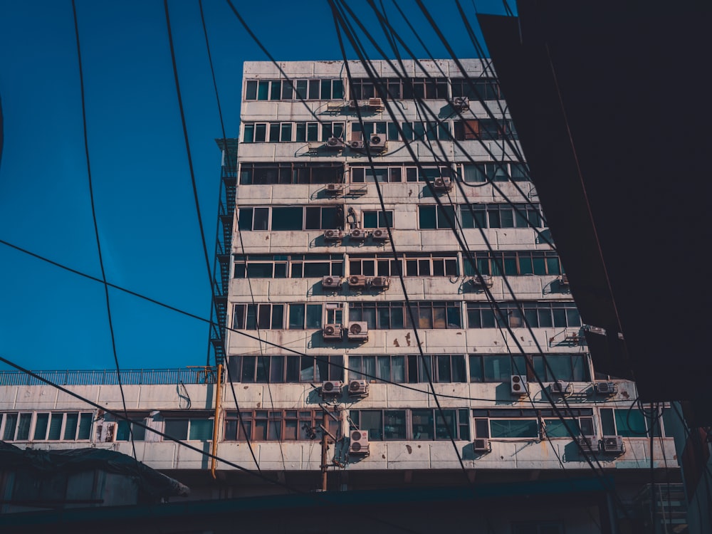 a tall white building with lots of windows