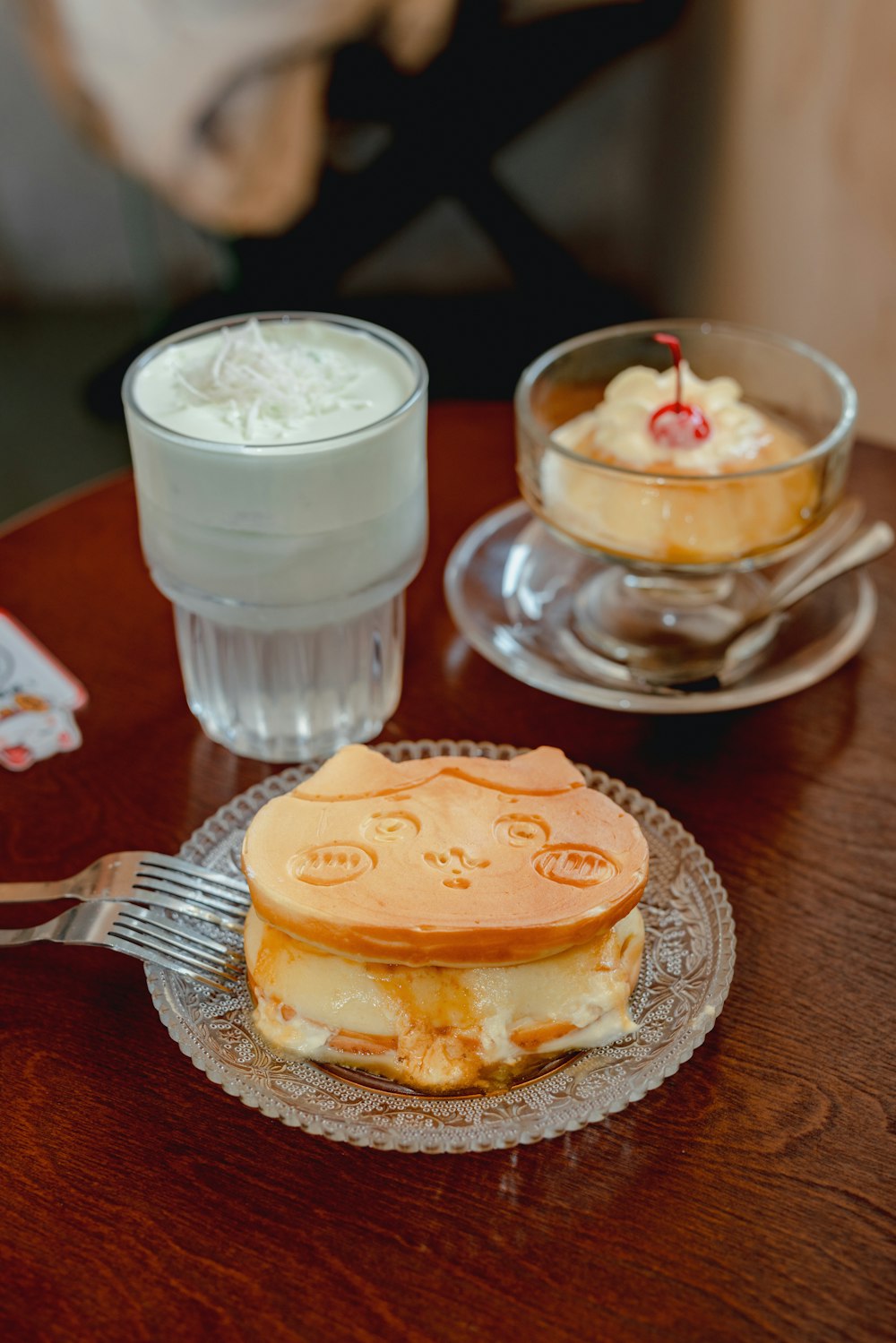 a plate with a sandwich on it next to a glass of milk