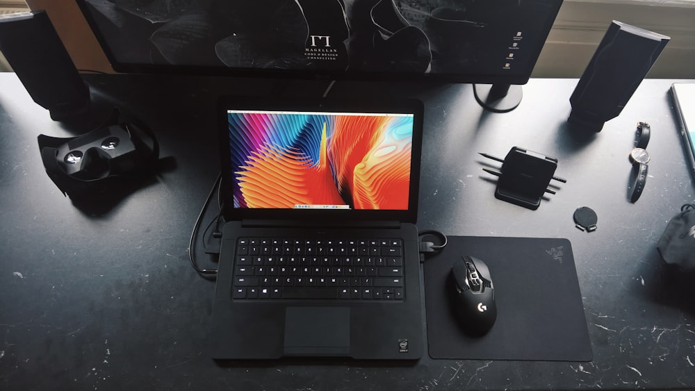 a laptop computer sitting on top of a desk