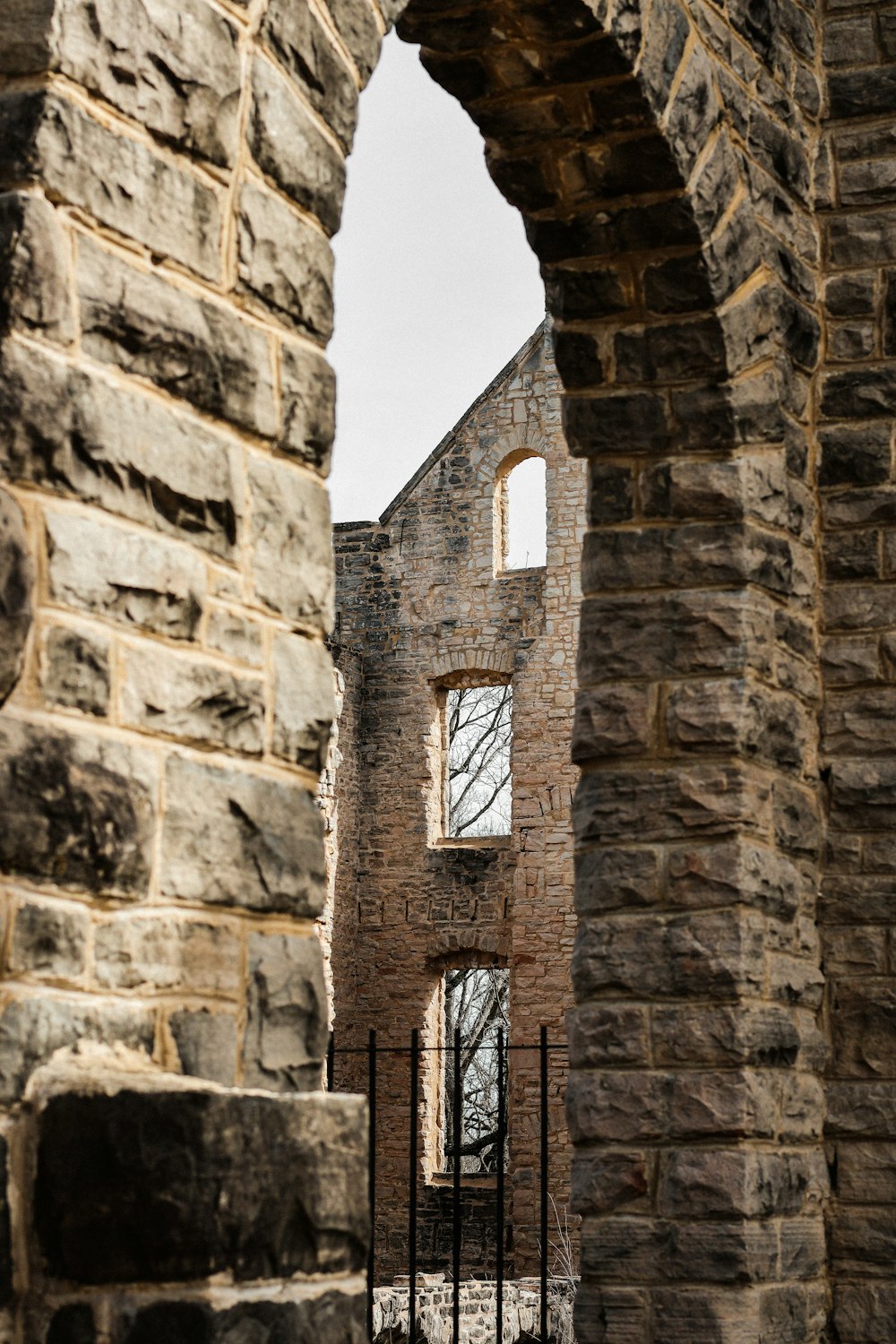 a stone building with a gate and a window