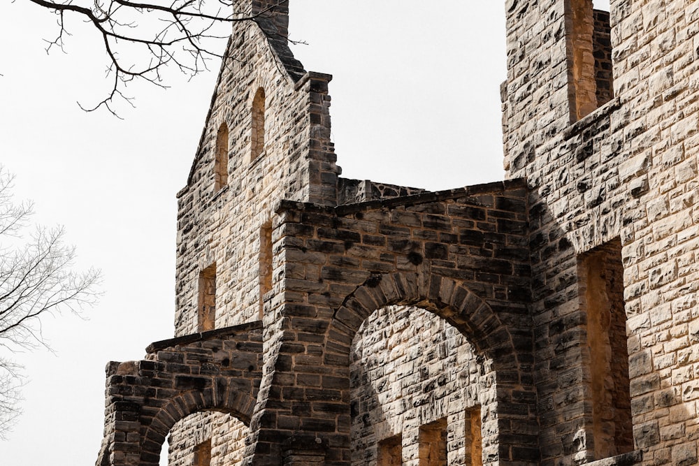 a stone building with arches and a clock tower