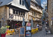 a cobblestone street lined with tables and chairs
