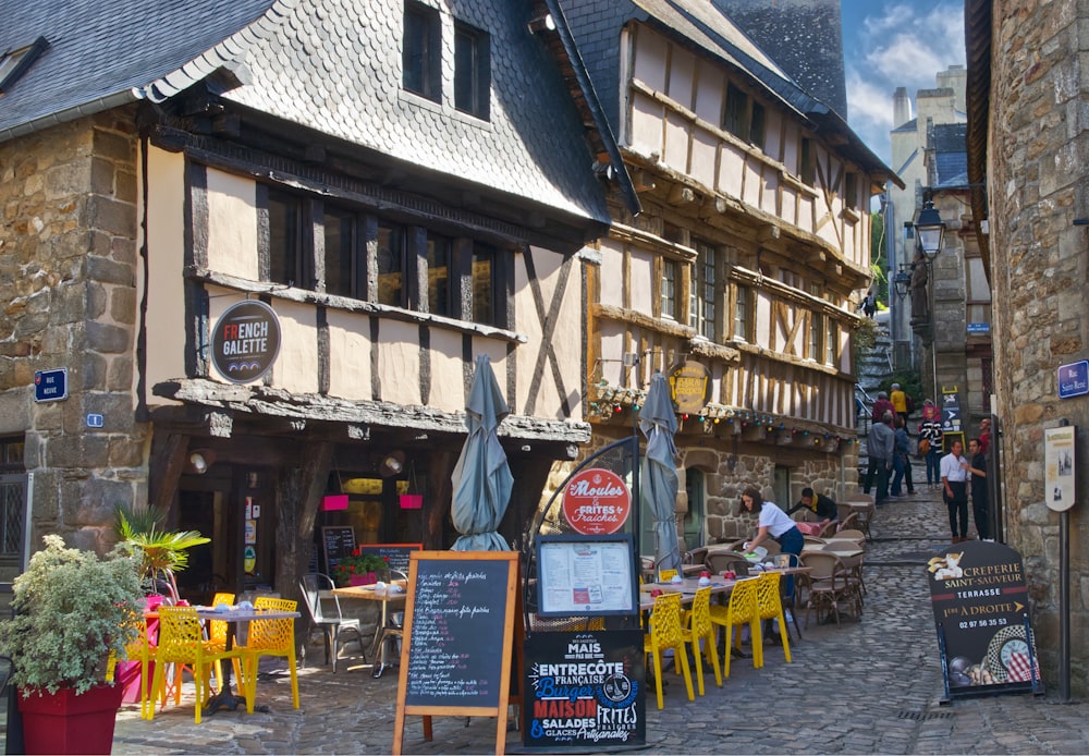 a cobblestone street lined with tables and chairs