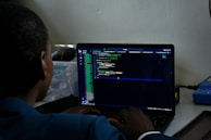 a man sitting in front of a laptop computer
