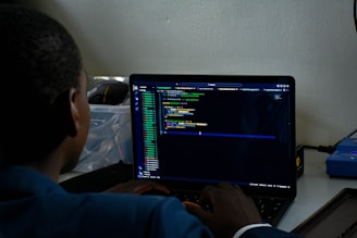 a man sitting in front of a laptop computer