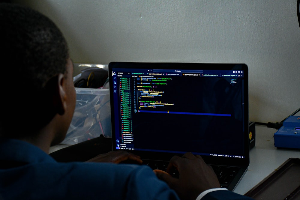 a man sitting in front of a laptop computer