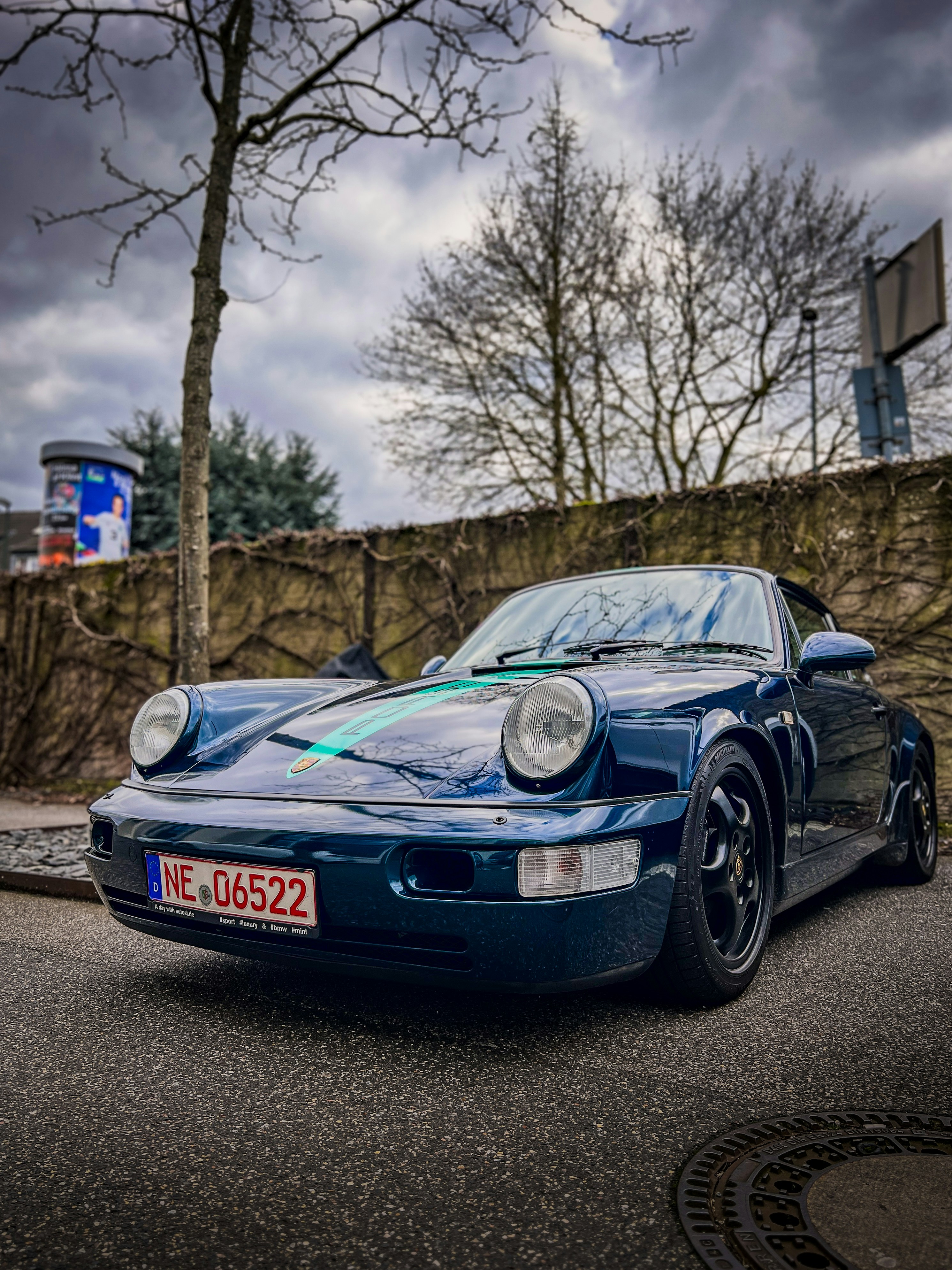 a blue sports car parked on the side of the road