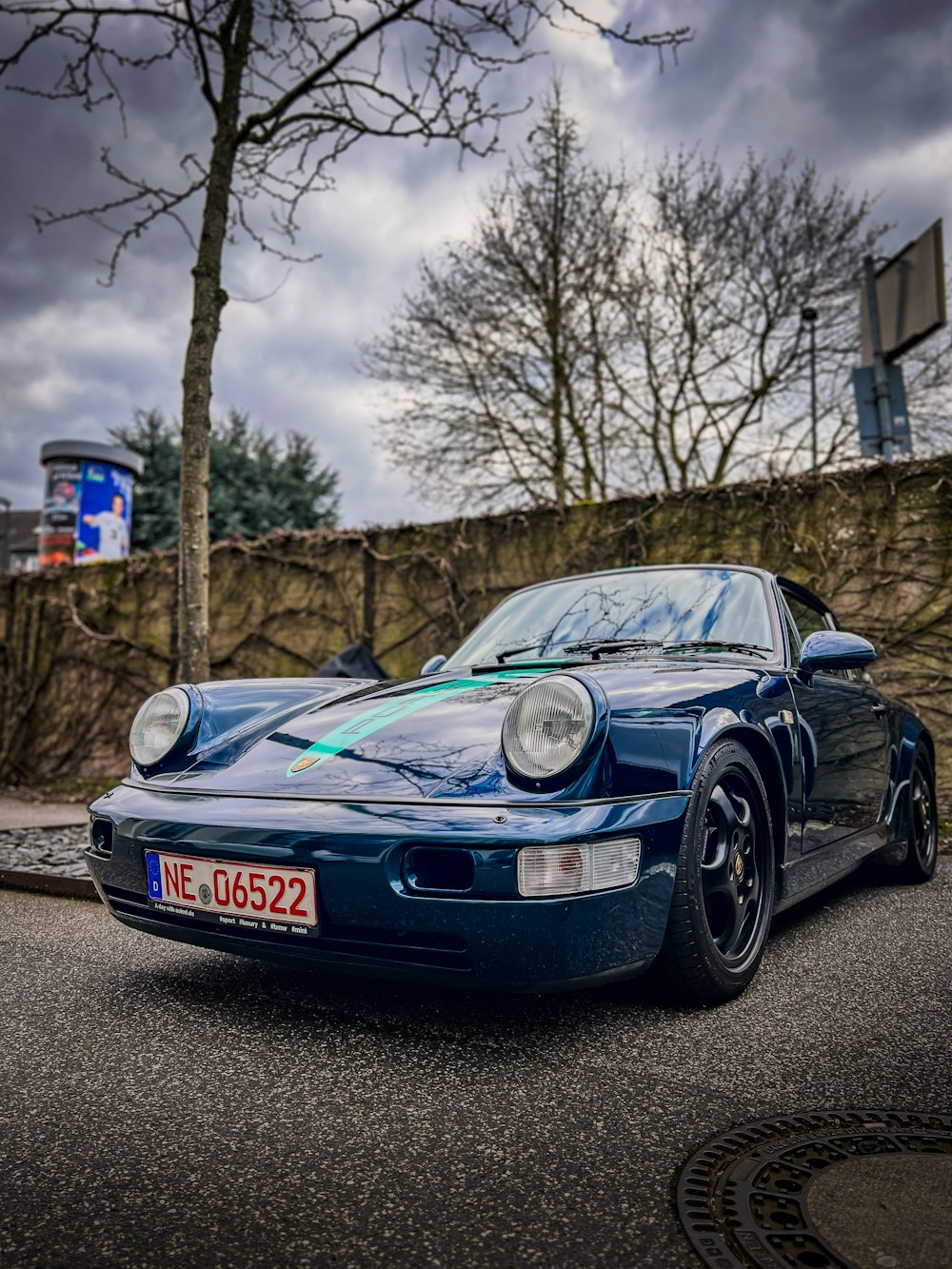 a blue sports car parked on the side of the road