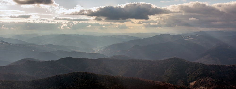 a view of a mountain range with clouds in the sky