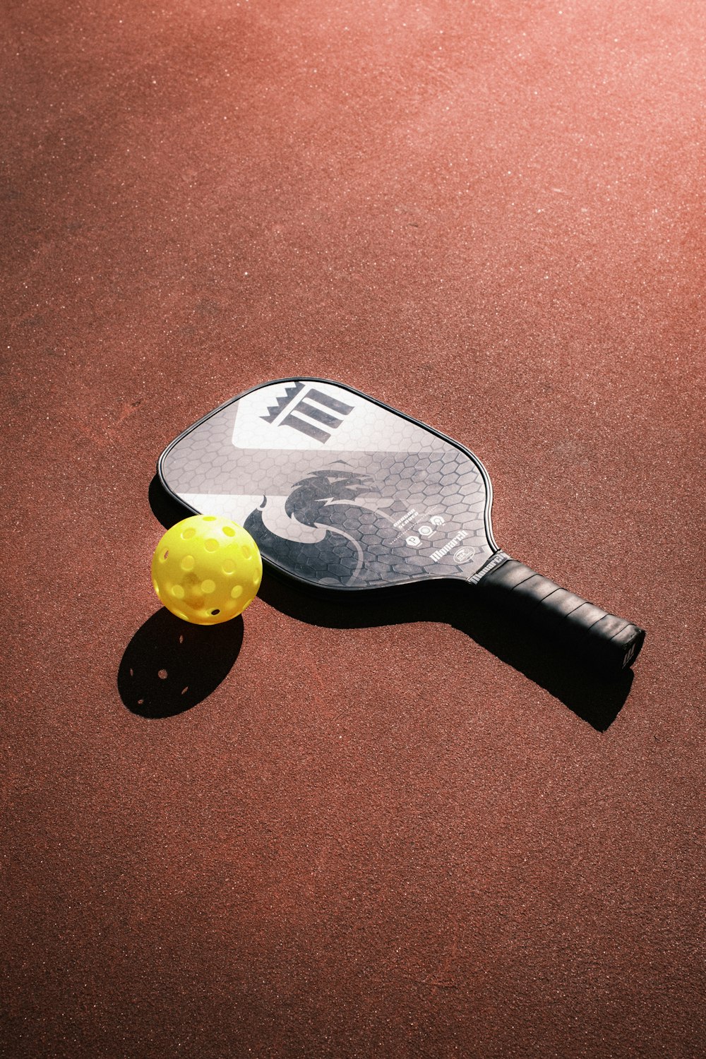 a tennis racket and ball on a court
