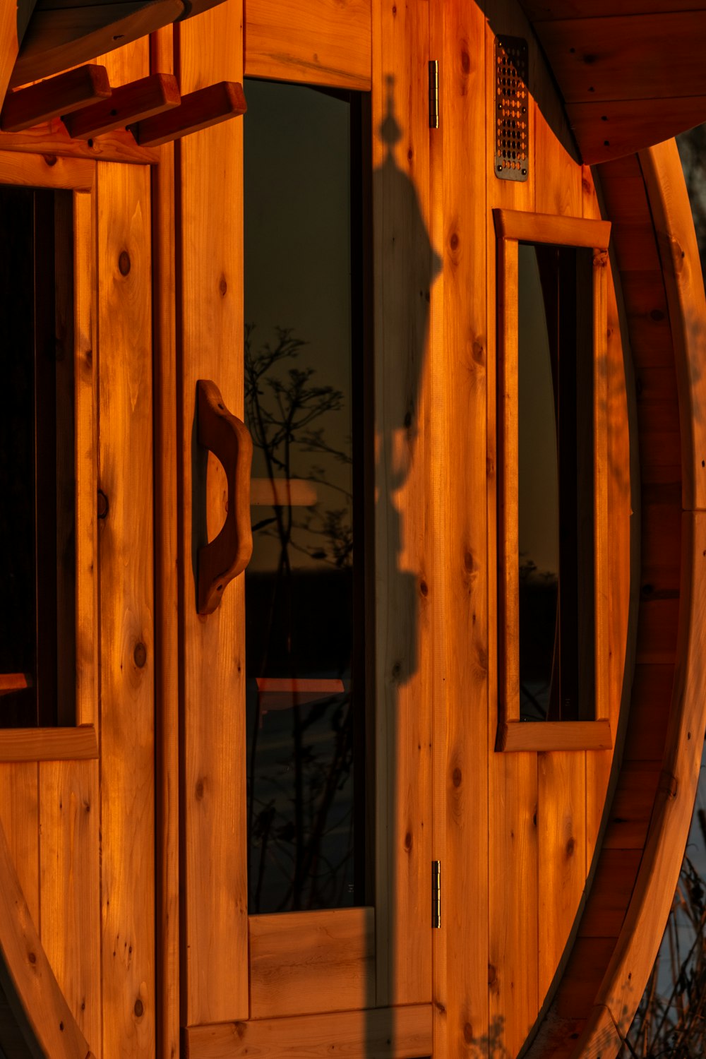 a wooden building with a large round window