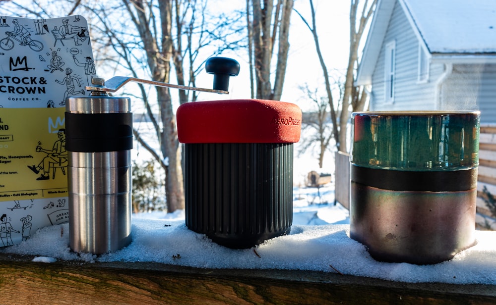 a couple of cups sitting on top of snow covered ground