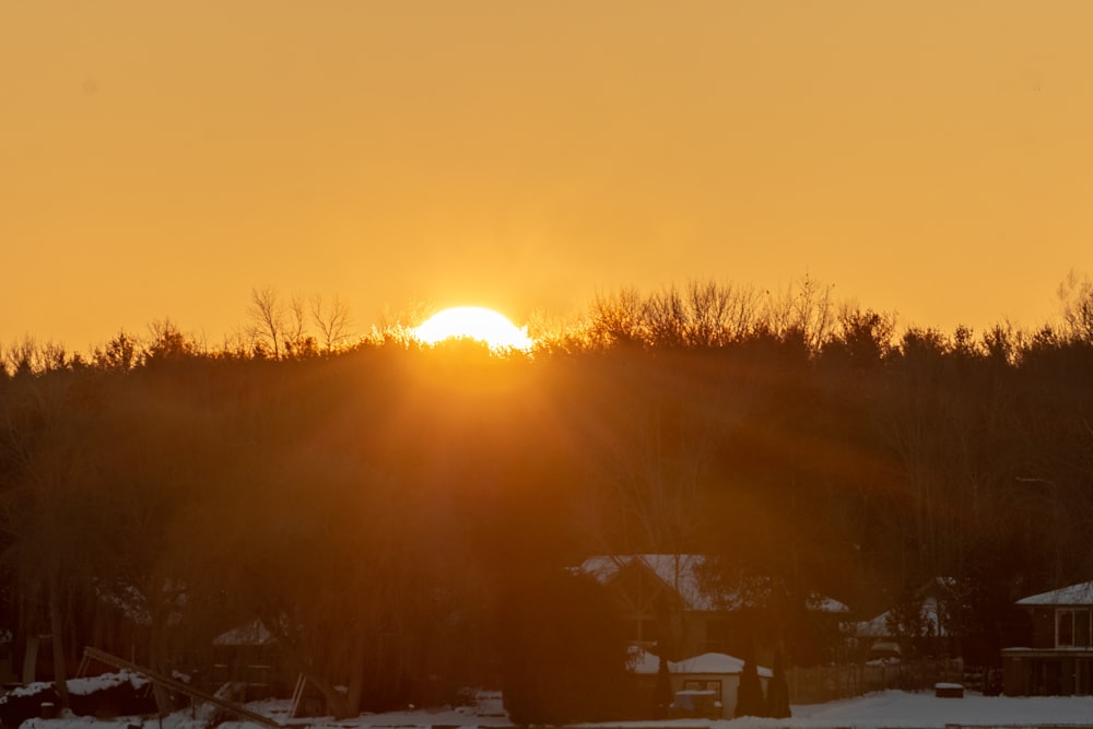 the sun is setting over a small town