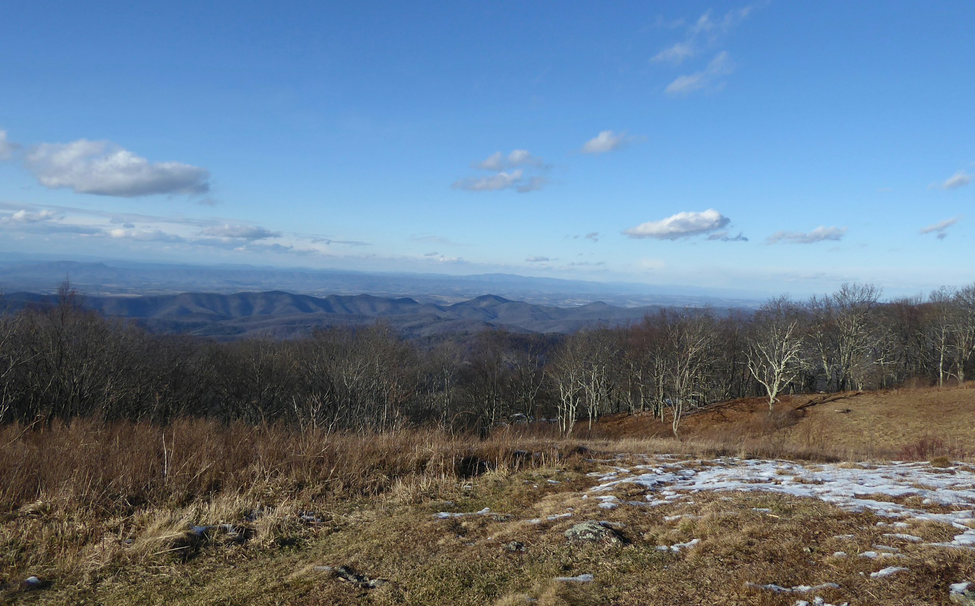 a view of the mountains from the top of a hill