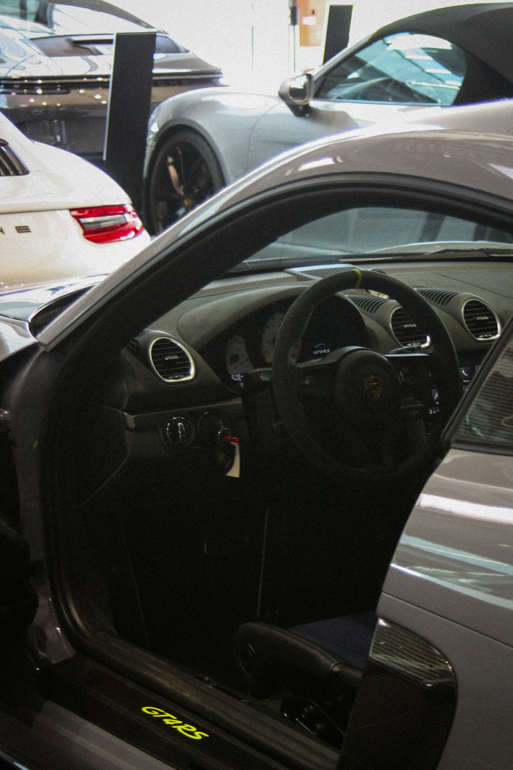 the interior of a sports car with the door open