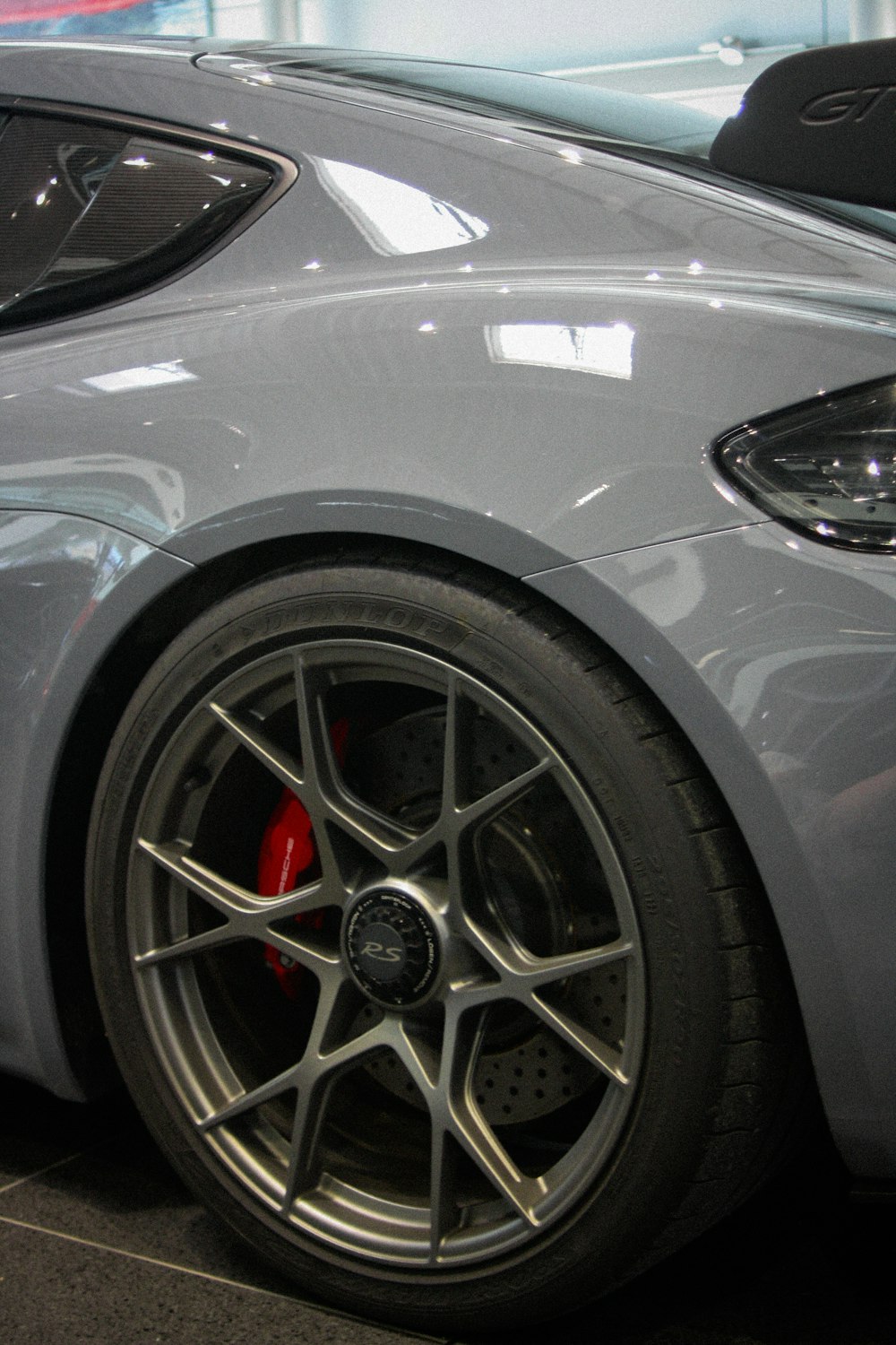 a grey sports car parked in a garage