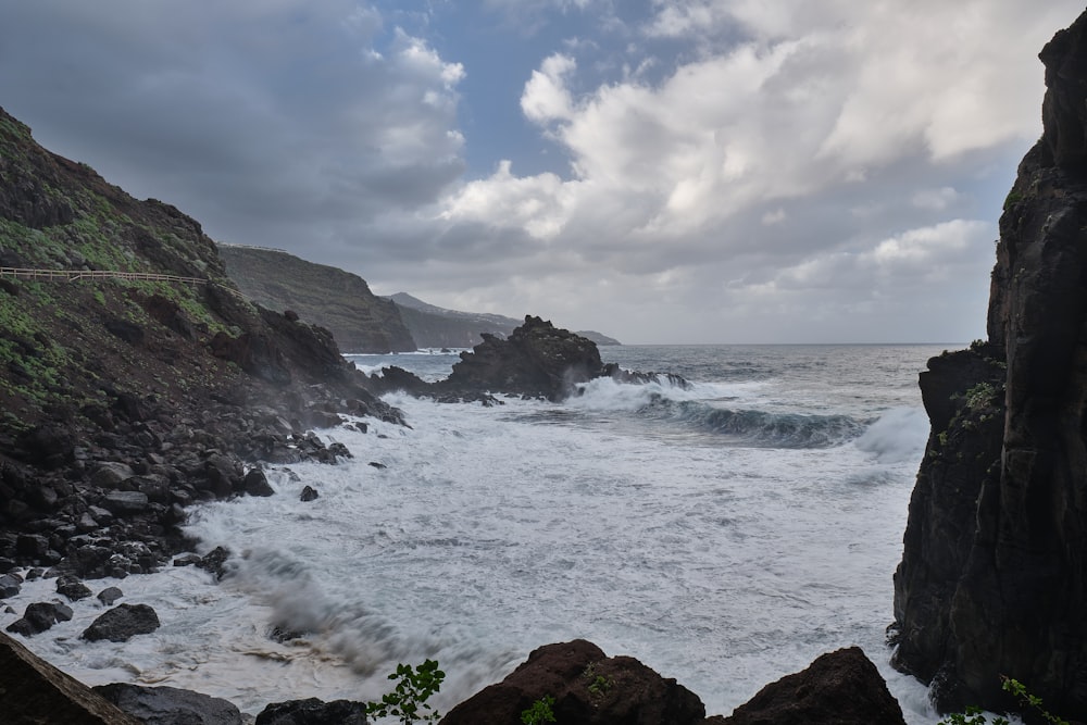 a view of the ocean from a rocky cliff