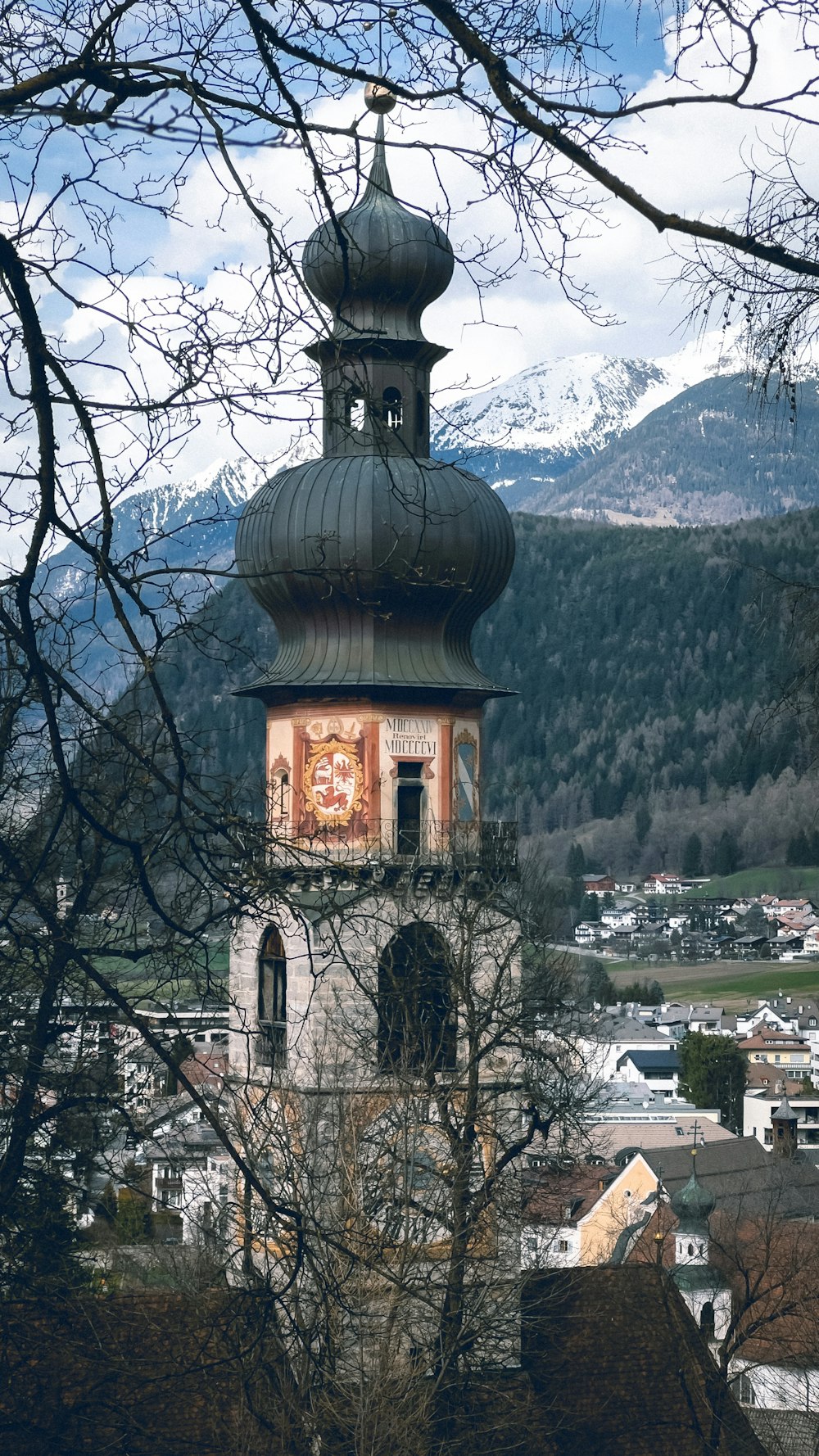 a church tower with a painting on the side of it