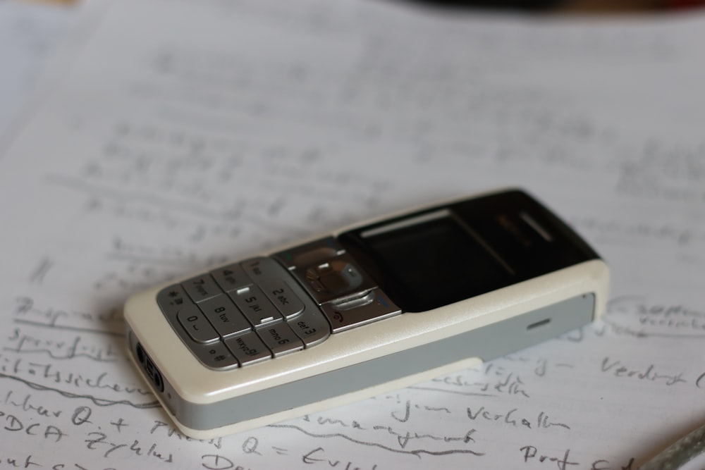 a cell phone sitting on top of a piece of paper
