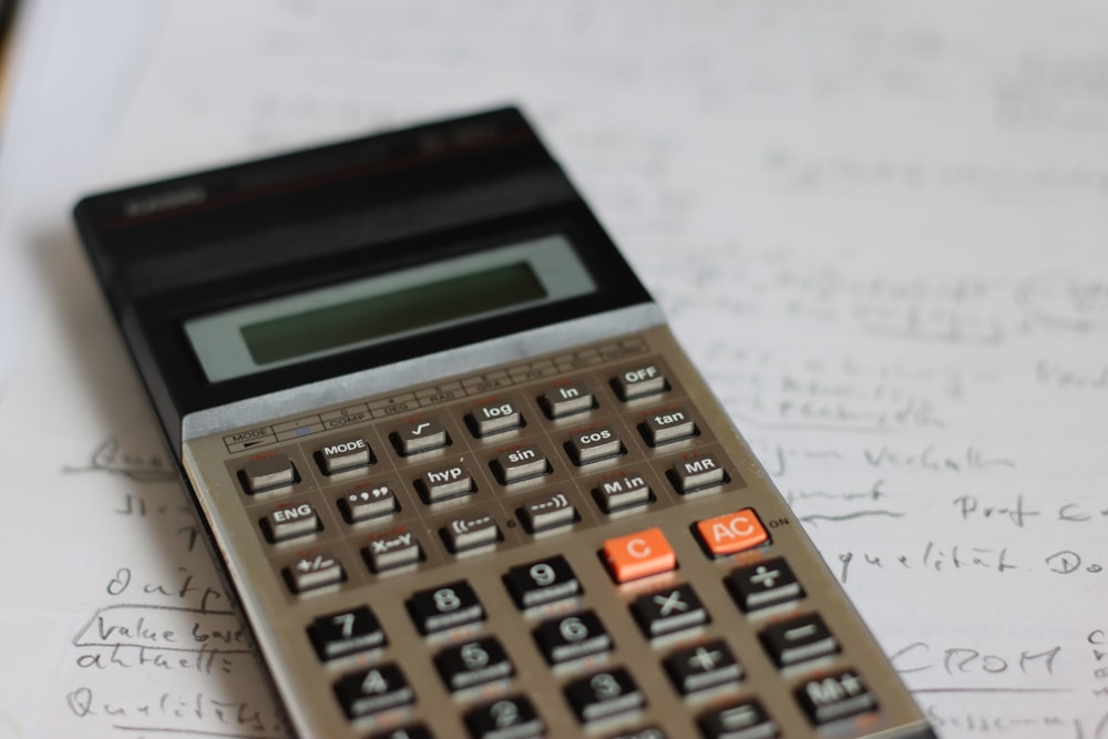 a calculator sitting on top of a piece of paper