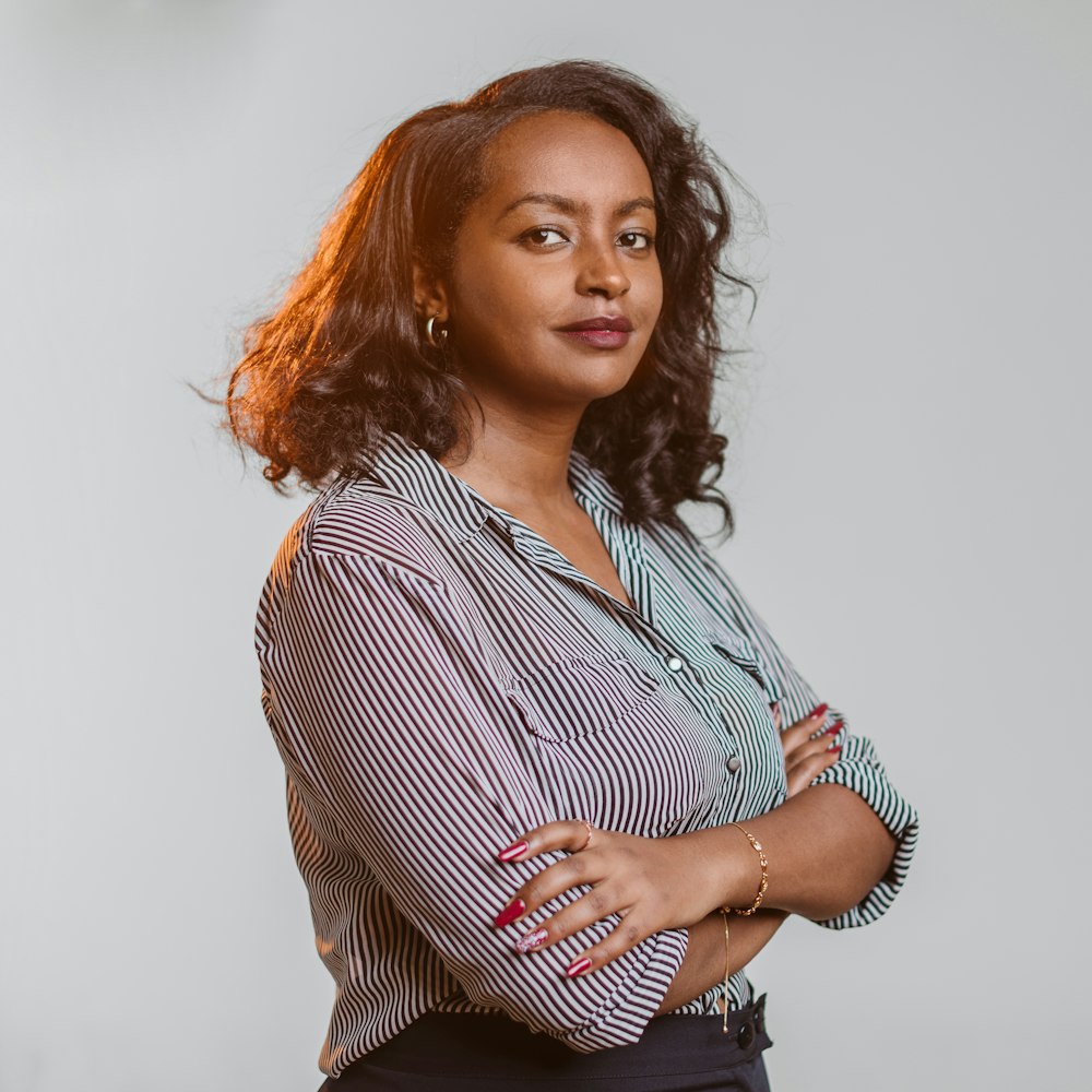 a woman standing with her arms crossed