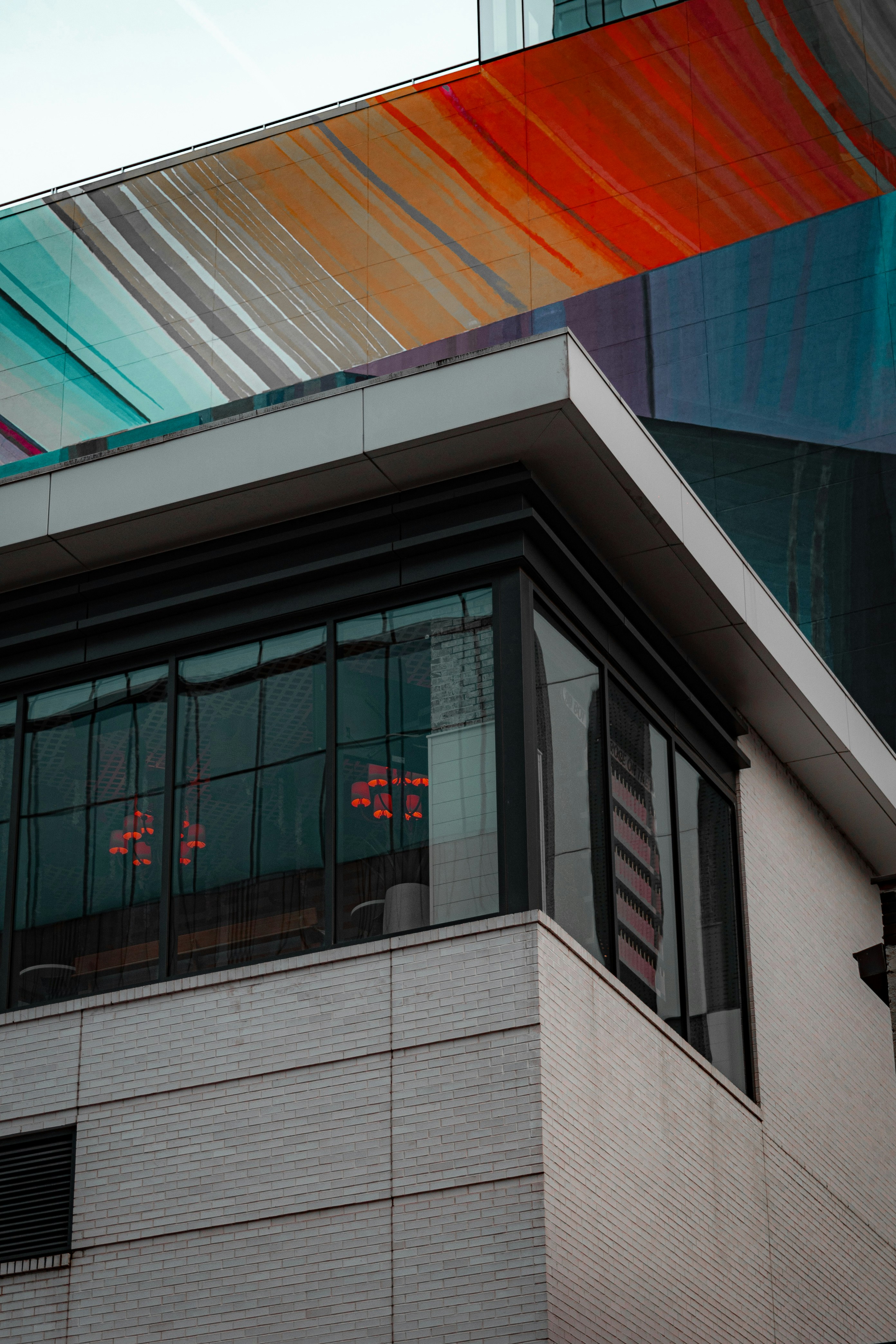 a tall building with a multicolored roof