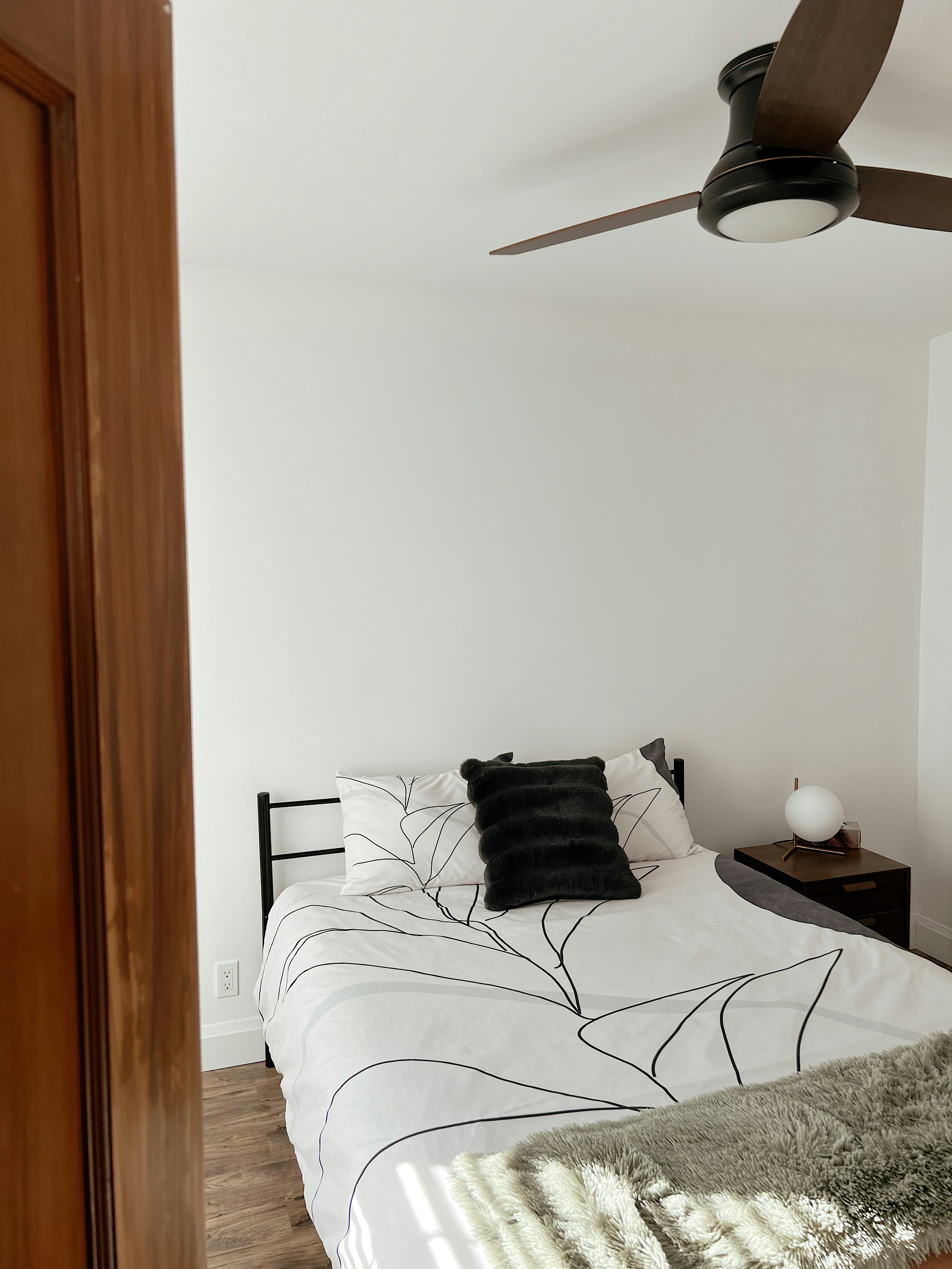 a bedroom with a bed and a ceiling fan